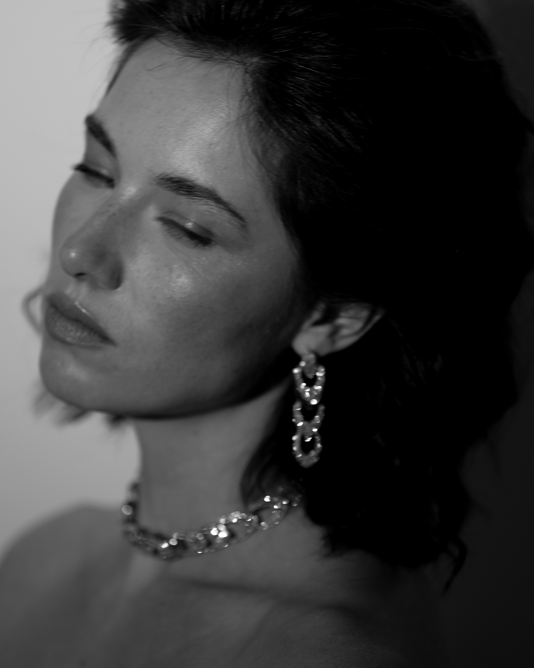 Black and white Zorae social portrait featuring sculptural earrings and necklace