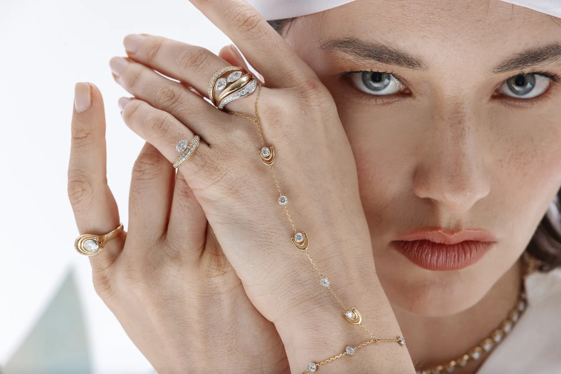Unbound Muse — model wearing solid gold rings, hand chain and diamond necklace from the Unbound collection