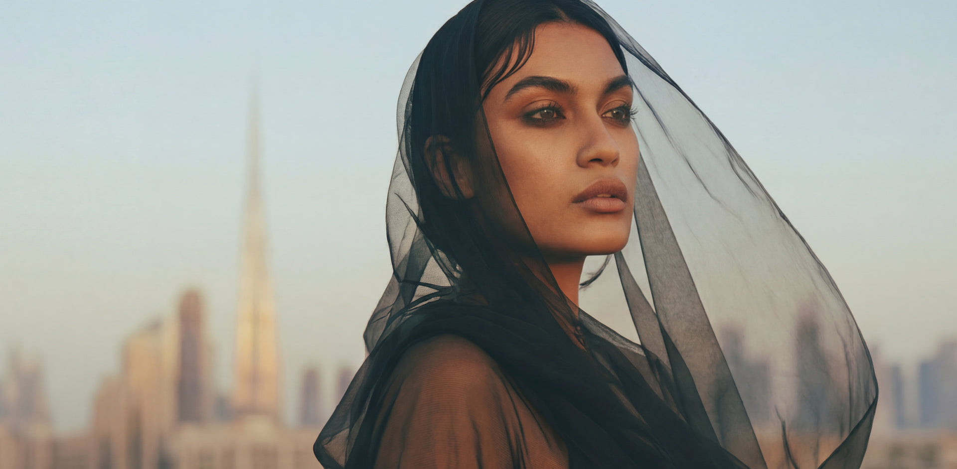 Model wearing jewelry in Dubai skyline