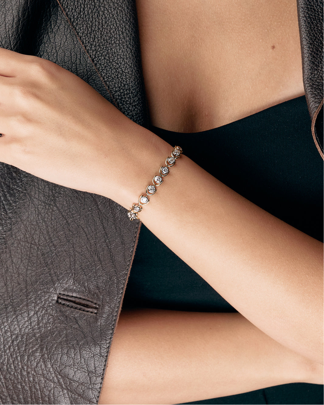 Bracelet on a person's wrist with a dark background